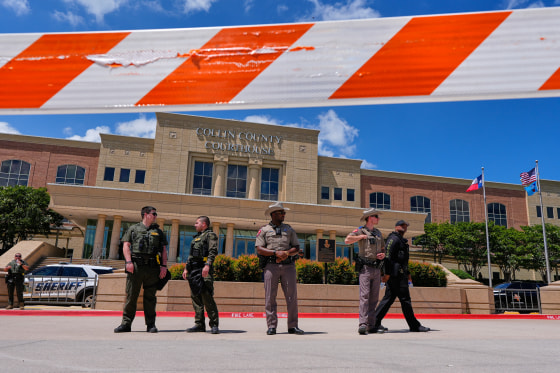 Law enforcement officials stand in front of the Collin County courthouse.