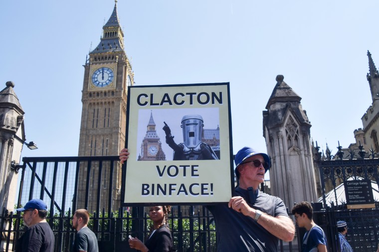 An activist holds a placard urging Clacton to vote for the