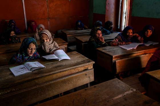 Afghan girls attend a class at a primary school.
