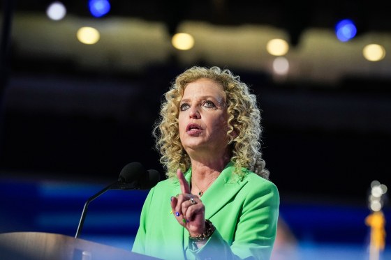 Debbie Wasserman Schultz speaks at a podium in an arena