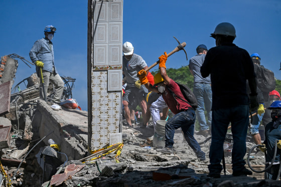 Rescuers help remove debris.