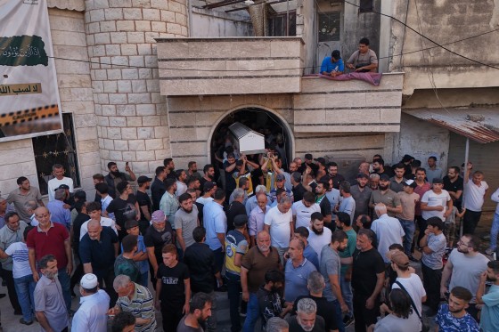 Mourners carry the coffin of Mohammad Ghamira