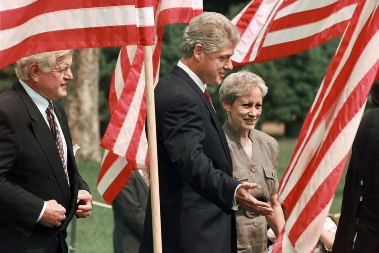 Nancy Kassebaum Baker,Bill Clinton,Edward Kennedy walk between American flags on the White House lawn.