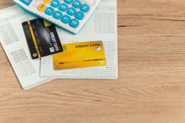 Credit cards and financial documents are placed on the desk.