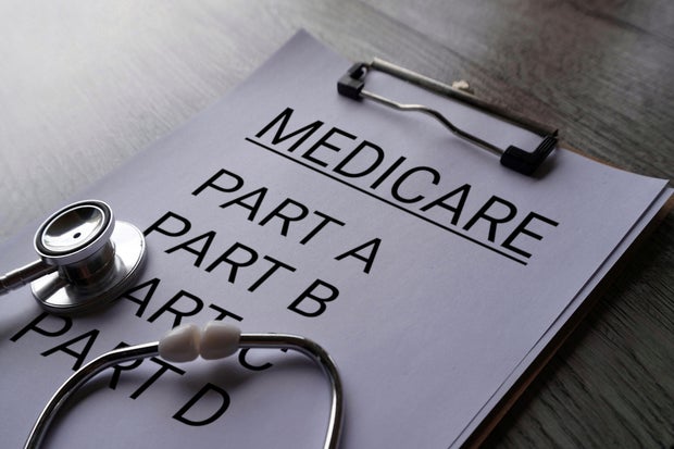 Close up image of stethoscope and paper clipboard with text MEDICARE and part list. 