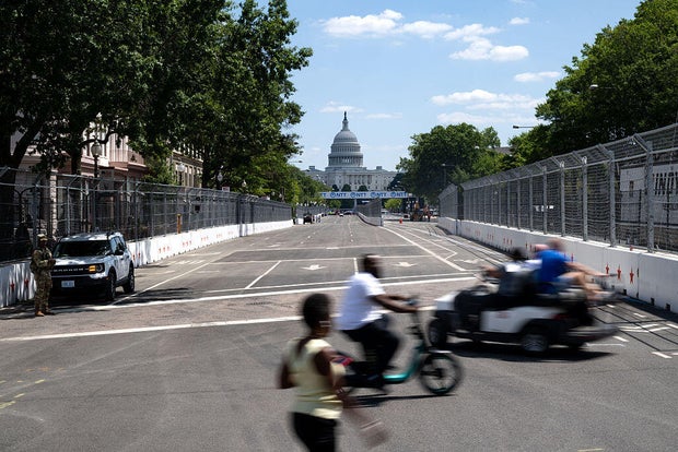 People cross the racetrack along Pennsylvania Avenue on Aug. 19, 2026. 